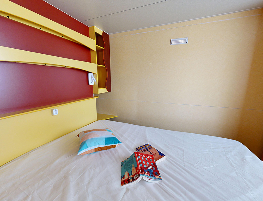 Slaapkamer met 1 tweepersoonsbed in de klassieke stacaravan van 25 m² voor 5 personen, te huur op de 4-sterrencamping Le Neptune in Agde.
