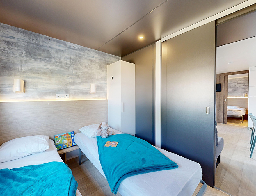 Zimmer mit zwei Einzelbetten im Mobilheim Premium 29 m², zu mieten auf dem 4-Sterne-Campingplatz Le Neptune in Agde